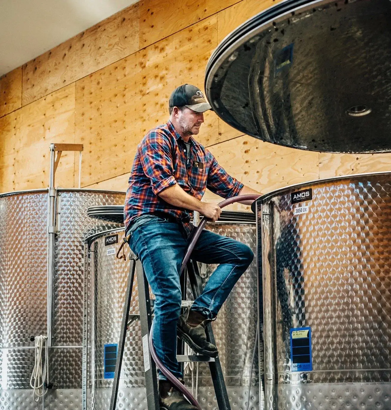 Dylan Roche working among wine tanks