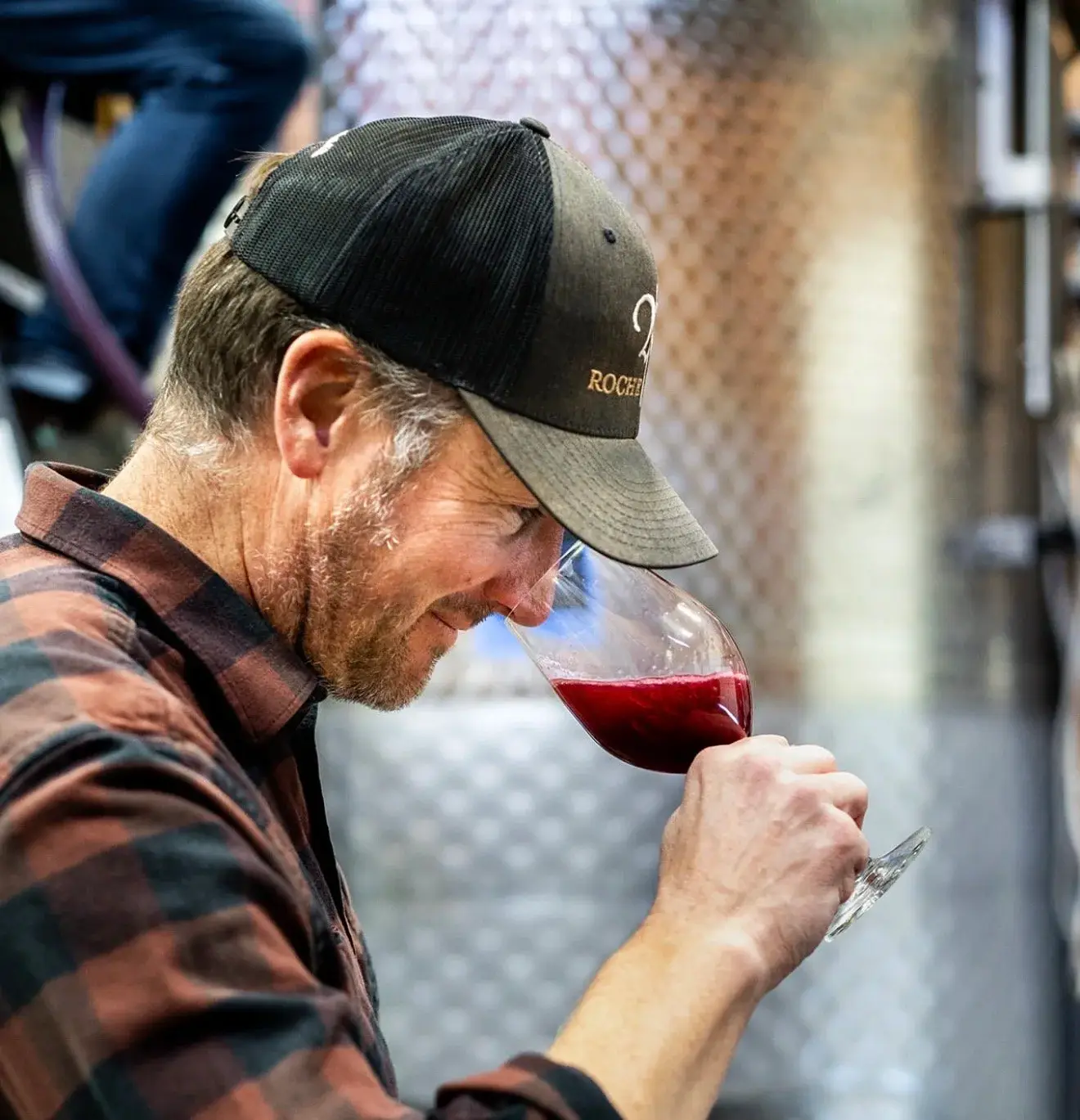 Dylan Roche tasting wine in the cellar
