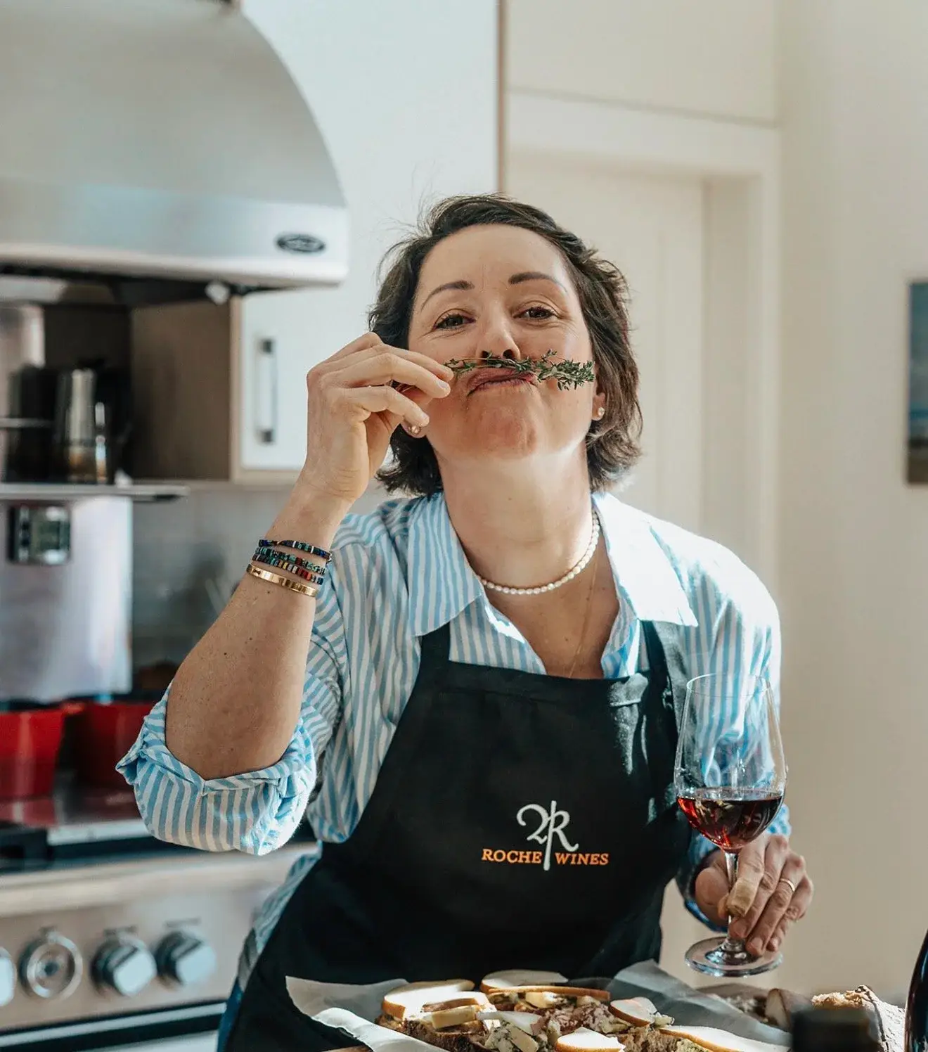 Penelope Roche smelling herbs with wine
